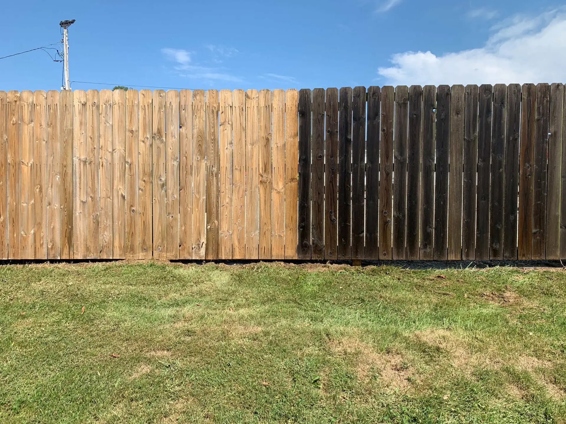 Fence Cleaning Wood fence cleaning split view showing clean side next to dirty side in Kenwood, OH
