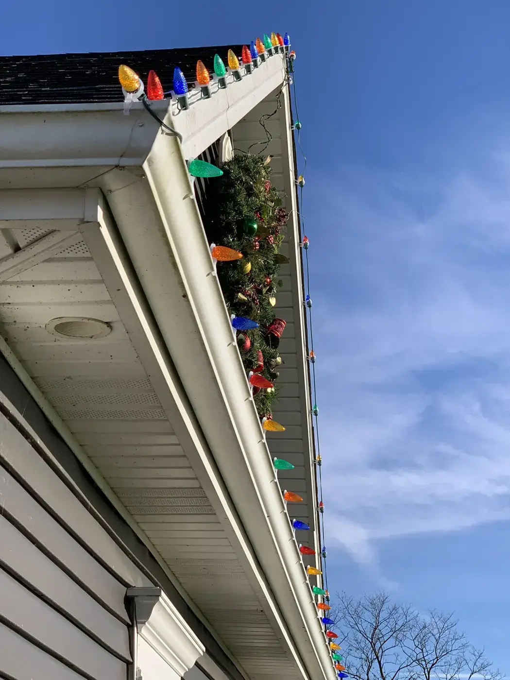Christmas Light Installation in Hebron, KY Close-up of multicolor C9 Christmas bulbs clipped to a gutter