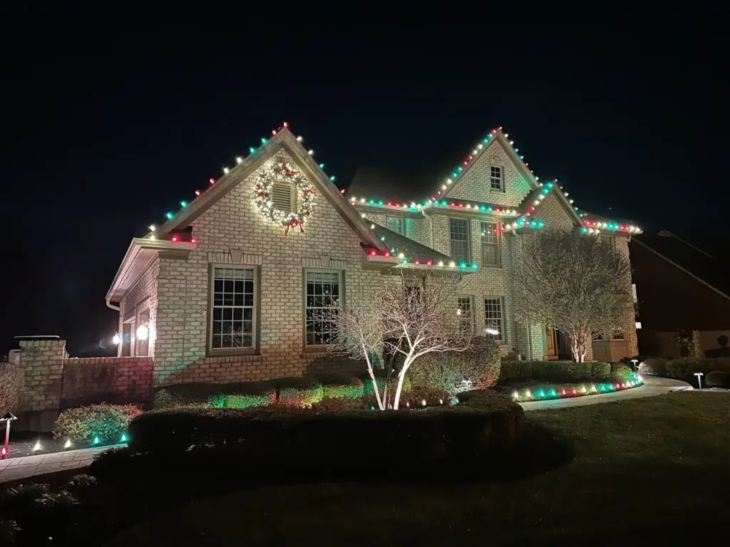 Christmas Lighting Red and green C9 Christmas lights with a lighted wreath and landscape lighting
